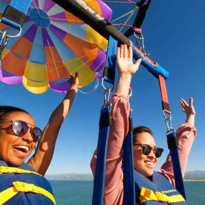 a group of people standing next to a body of water