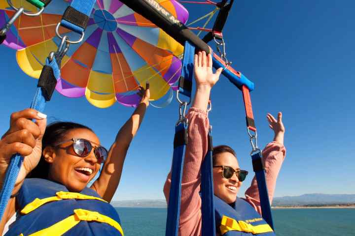 a group of people standing next to a body of water